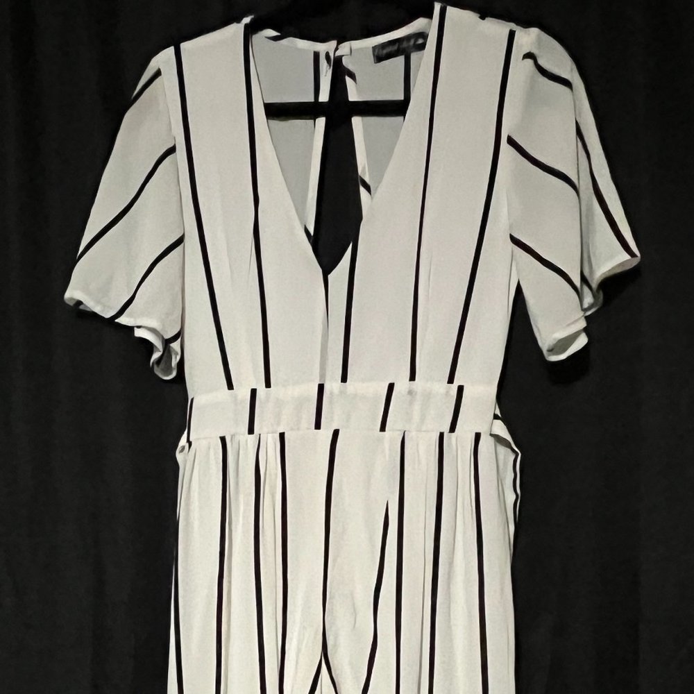 Lightweight white and black striped romper with attached cape.